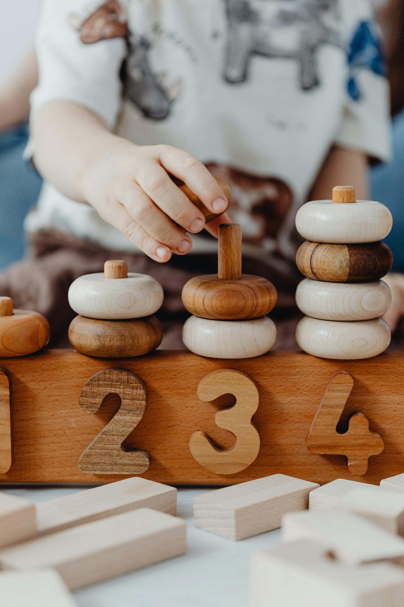 A child interacts with educational wooden number blocks, enhancing cognitive skills.